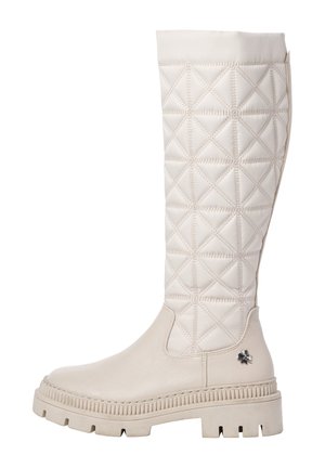 Kremfarvet støvle til knæet med polstret stofskaft, tyk rillede sål og lille metalblomstemblem på hælområdet.