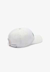 Gorra blanca de algodón con forma redondeada, que presenta un logo bordado y una correa ajustable en la parte trasera. Textura suave con visera curvada.