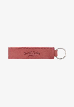 Leather keychain strap in dusty pink with stitched edges and metal ring, branded with "Gusti Leder studio" text.