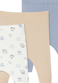 Drie paar leggings: beige, lichtblauw en wit met lichtblauwe en bruine voertuigpatronen. Zacht, rekbaar katoen.