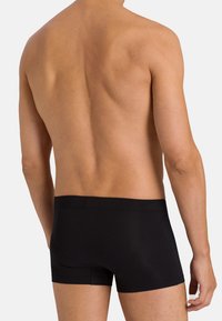 Black boxer briefs made of a soft, elastic material; features a snug fit and a seamless design with a comfortable waistband.