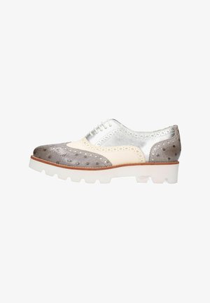 Men's oxford shoe featuring a silver metallic upper, gray textured accents, and a white chunky sole. Brogue detailing along edges.