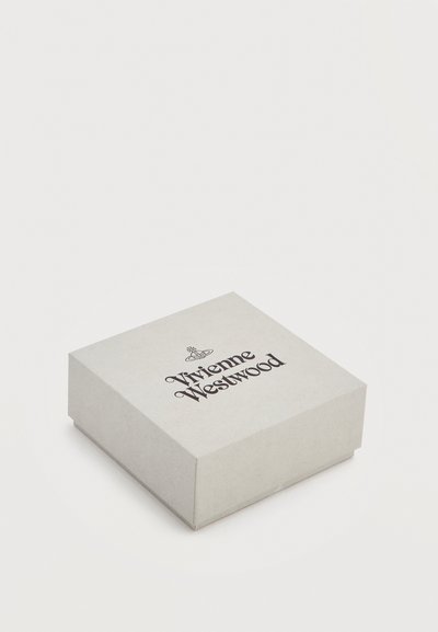 Κλειστό λευκό τετράγωνο κουτί με το λογότυπο και το έμβλημα της Vivienne Westwood στην κορυφή, τοποθετημένο σε ανοιχτό φόντο.