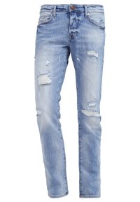 Jasnoniebieskie dżinsy o stylu zniszczonym, z wieloma przetarciami, prostym krojem, pięcioma kieszeniami i zapięciem na guzik.