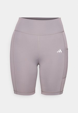 Venyttävät, laventelinväriset pyöräilyhousut, joissa on korkea vyötärö. Ominaisuuksiin kuuluvat litteät saumat ja sivutasku. Huomattava Adidas-logo valkoisena vasemmassa alareunassa.