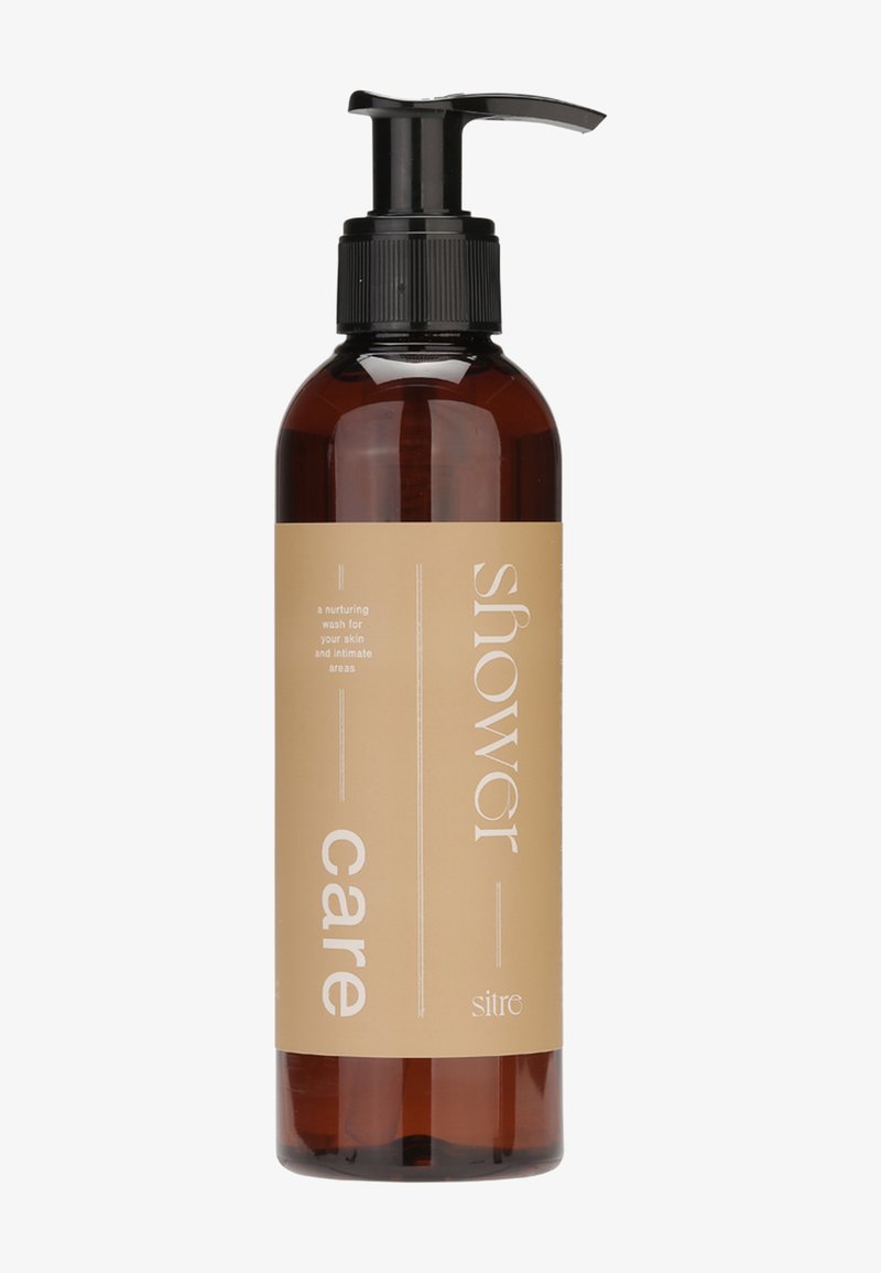 Flacon-pompe ambré avec une étiquette beige portant l'inscription "soin de la douche", un lavage nourrissant pour la peau et les zones intimes, nom de la marque Sitro en bas.