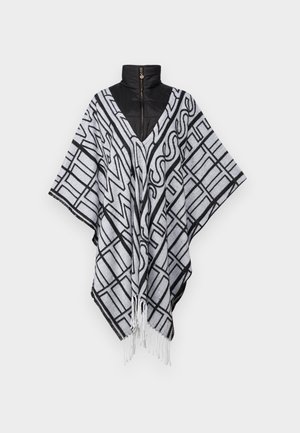 Schwarz-weißer gemusterter Poncho mit einem V-Ausschnitt, fransigem Saum und darunter einer schwarzen Steppjacke mit hohem Kragen. Weicher Stoff und lockere Passform.