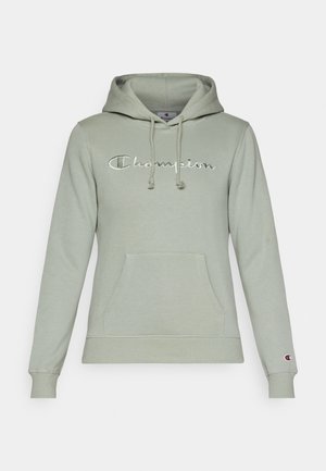 Lys grøn hoodie lavet af en bomuldsblanding, med en frontlomme, snoretræk i hætten og broderet "Champion" logo i hvid.