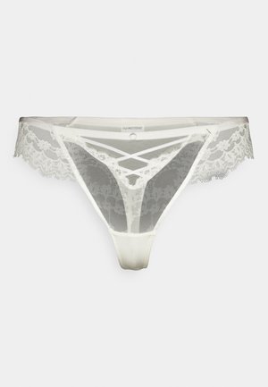 Lace en mesh string in licht ivoor. Kenmerkt zich door ingewikkelde kantafwerkingen, geometrische uitsparingen en een gladde zijde-achtige voorkant. Dunne bandjes aan de zijkanten.