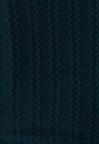 Dark teal fabric with a textured pattern of raised stripes, featuring a woven design that creates depth and visual interest.