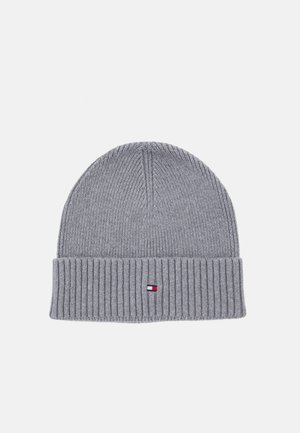 Gray knitted beanie with a ribbed texture, featuring a folded cuff. A small logo tag in red, white, and blue is stitched on the front.