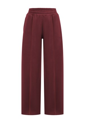 Pantalons de jogging amples, bourgogne, avec une taille élastique, présentant des détails de couture contrastants et une texture de tissu lisse.