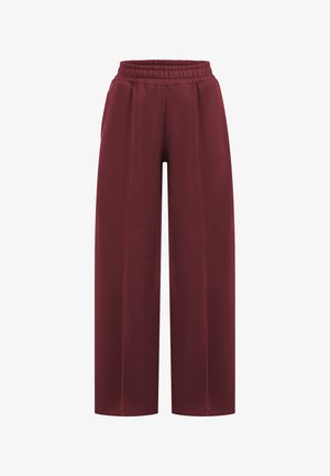 Weite, burgunderfarbene Sweatpants mit elastischem Bund, die kontrastierende Nähte und eine glatte Stoffoberfläche aufweisen.