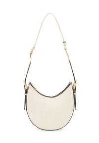 Bolso hobo en faux cuero crema con forma curva, herrajes en tono dorado, logo "TOUS" en relieve y detalle de cremallera negra contrastante.