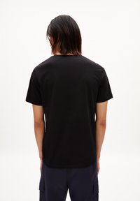 Zwarte katoenen t-shirt met een ronde hals en korte mouwen, met een gladde textuur en een eenvoudig, minimalistisch ontwerp.