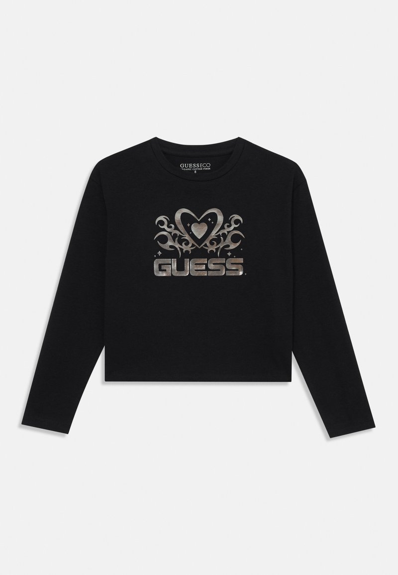 Black cropped long-sleeve t-shirt, featuring a silver decorative "GUESS" logo with heart and swirl accents on the front. Soft cotton material.