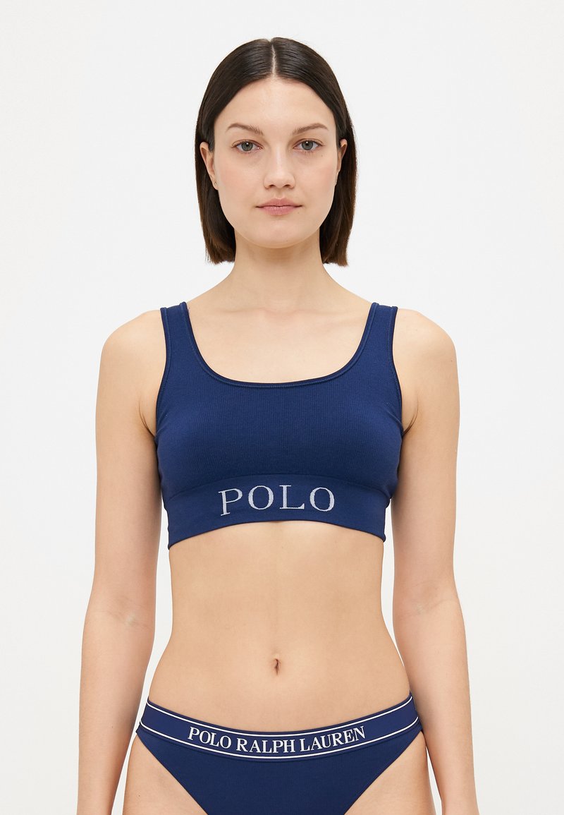 Navy blue cotton bralette with a ribbed texture and a wide waistband featuring "POLO" logo in silver. Matching navy blue panties with logo band.