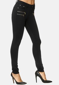 Zwarte skinny broek van rekbare stof, voorzien van gouden ritszakken en een aansluitend ontwerp met een gladde textuur en slanke silhouet.