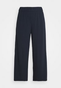 Navy blauwe, wijde broek van een textuurstof met een ribbelstructuur en een elastische tailleband. Heeft een vloeiende uitstraling voor comfort en bewegingsvrijheid.