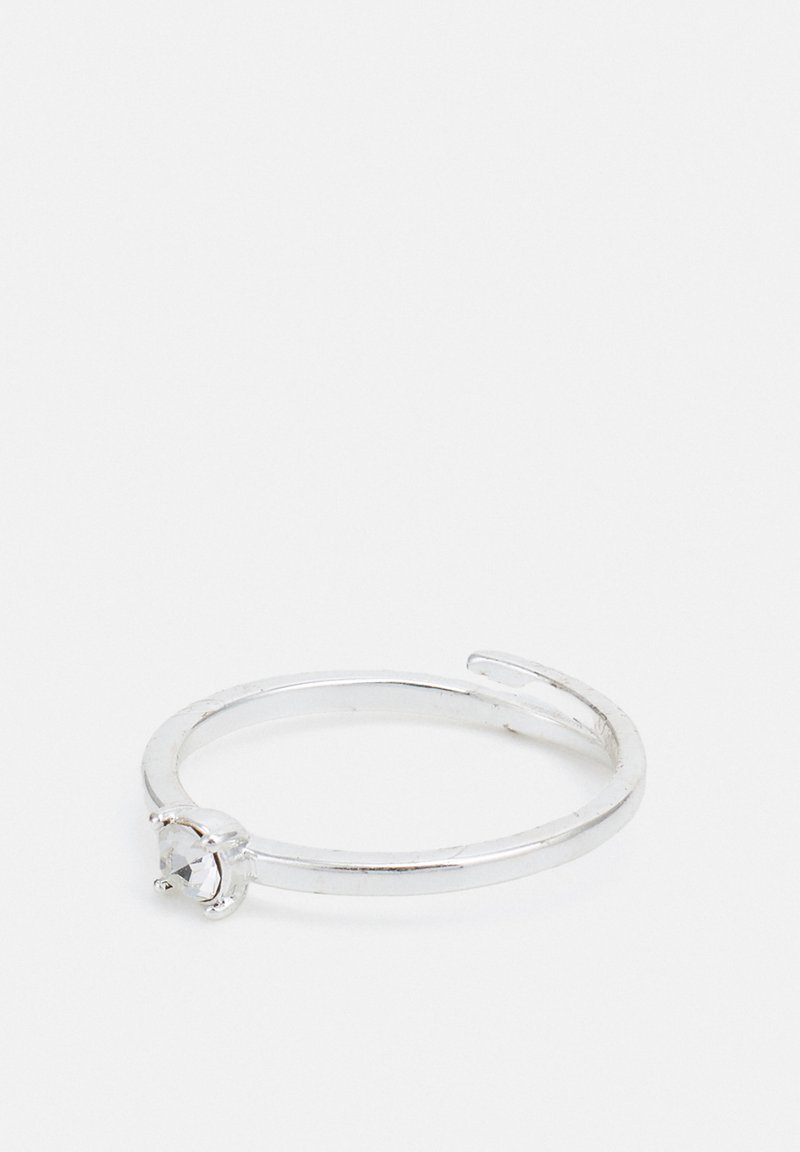 Srebrni prsten s jednostavnim dizajnom trake, sa prozirnim draguljem postavljenim u postavku na četiri zupca; glatka tekstura.