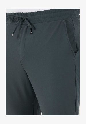 Dunkelgraue Sporthose mit elastischem Bund, Kordelzug und Seitentaschen. Glatte Textur und taillierte Passform für hohen Komfort.