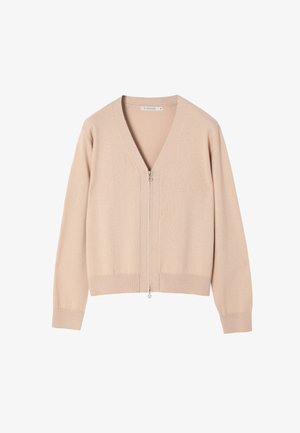 Gilet beige clair en tissu doux, avec un col en V, des manches longues et une fermeture éclair à l'avant avec des garnitures en argent. Design simple et sans ornements.