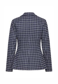Blazer bleu marine avec motif à carreaux blanc, manches longues, taille cintrée et légère évasement aux hanches, vu de dos.