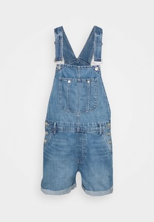 Niebieskie krótkie ogrodniczki z denimu z regulowanymi szelkami, przednią kieszenią na piersi, bocznymi guzikami i podwiniętymi nogawkami.