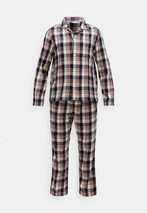 Kostkovaný pyžamový set v námořnické modré, červené a smetanové barvě. Dlouhý rukáv s knoflíky a límečkem, odpovídající kalhoty, měkký materiál a volný střih.
