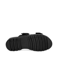 Black sandal sole with textured grip pattern, featuring adjustable Velcro straps and a contoured shape for comfort. Flat profile design.