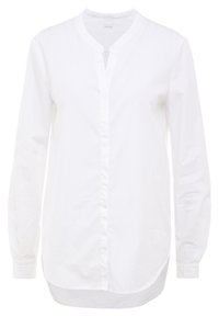Vit knäppt skjorta i bomull, med mandarin-krage, lång ärm, smal framknäppning och en något böjd nederkant.