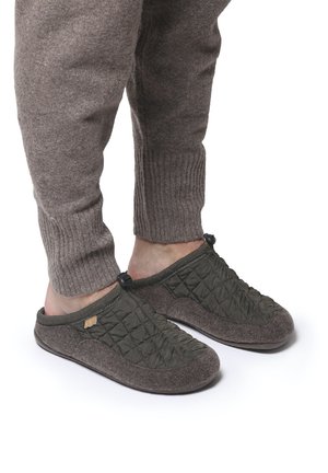 Quilted green fabric slip-on slippers with dark gray felt soles and black toggle accents, designed for comfort and ease of wear.