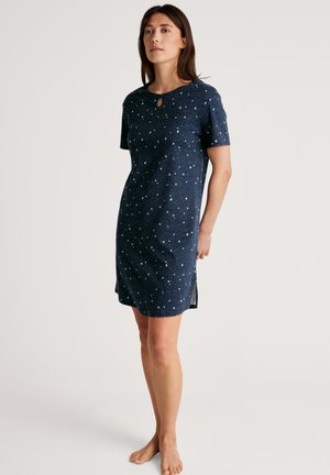Abito a maniche corte blu navy con scollatura a chiave, motivo stellato e spacchi laterali per una maggiore comodità. Tessuto morbido con vestibilità rilassata.