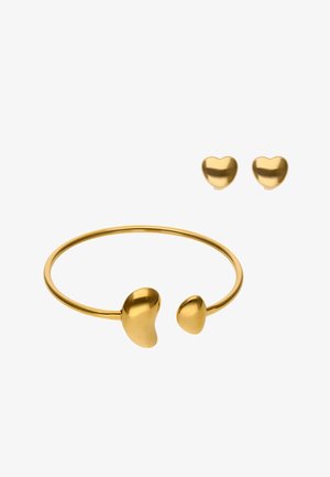 Bangles i guldfarve med hjerteformede ender og matchende ørestikker med hjerter, glat finish, minimalistisk design og afrundede kanter.