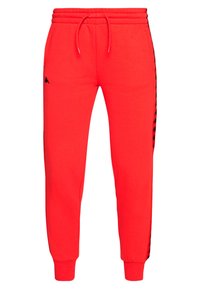 Red sweatpants made of cotton, featuring an elastic waistband, drawstring, and black side stripes with a logo on the left thigh.