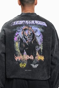 Black crewneck sweatshirt featuring a large colorful graphic of a skull and horns with text above, distressed texture, and band logos.