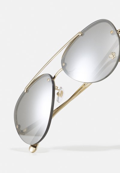 Metal sunglasses with gold frames, gray mirrored lenses, and a classic teardrop shape. Features include subtle nose pads and minimal detailing.
