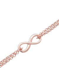 Armband i roséguld med en oändlighetssymbol som mittpunkt och en polerad yta, fäst vid en dubbelkedjedesign.