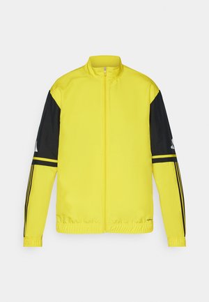 Yellow jacket with black sleeves, zip closure, elastic cuffs, and hem. Features three black stripes on each sleeve and a reflective logo.