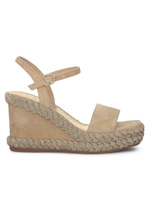 Beige suede wedge sandal with a wide toe strap, ankle strap, and decorative woven detailing along the wedge base.