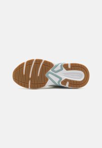 White athletic shoe sole with a textured brown rubber tread, featuring a light blue accent and a sleek design for traction and support.