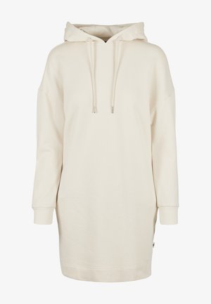 Abito felpa con cappuccio di colore crema, caratterizzato da una vestibilità ampia, maniche lunghe, cappuccio con coulisse e polsini a costine. Texture liscia e morbida.