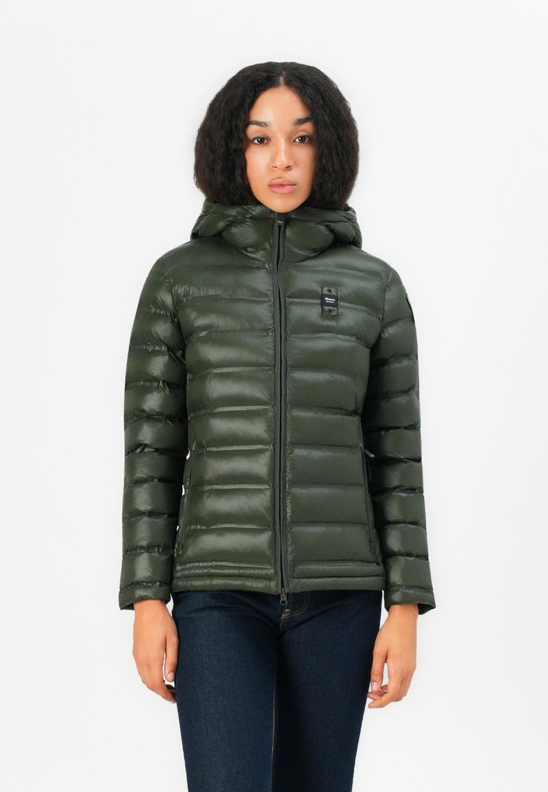 Green puffer jacket with a hood, featuring horizontal quilted panels, zip closure, and a small logo on the chest. Smooth, shiny texture.