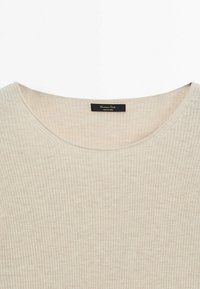 Beige ribbed knit sweater featuring a wide round neckline and a tag stating "Massimo Dutti, Made in China." Soft texture and casual design.