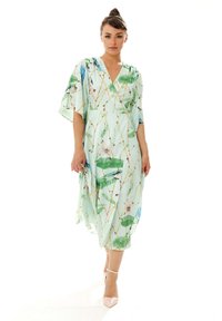 Floral-print dress in light mint green, featuring a V-neck, wide sleeves, and a flowy silhouette with leaf and bird patterns.