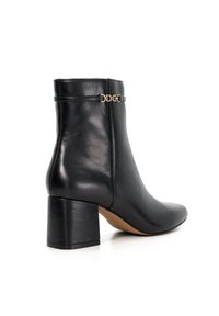Black leather ankle boot with a pointed toe, block heel, and gold chain accent near the ankle. Smooth texture and sleek design.