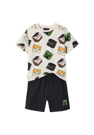 Kinder-Zweiteiler mit weißem T-Shirt, bedeckt mit Minecraft-Charakterköpfen, und schwarzen Shorts mit kleinem Creeper-Gesicht.