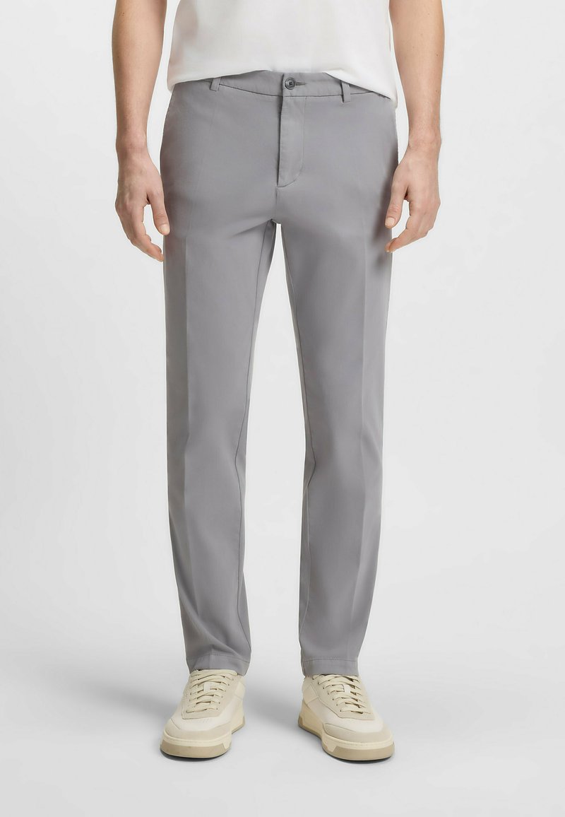 Gray, straight-leg trousers made of smooth fabric, featuring a front pocket, button closure, and belt loops, paired with light sneakers.