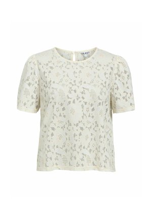 Blouse en dentelle crème à manches courtes avec motif floral, col rond, manches légèrement bouffantes et fermeture par boutons au dos.