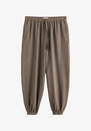 Brune bukser med elastisk talje og manchet ved anklerne, med sidelommer og snor foran, lavet af let stof.
